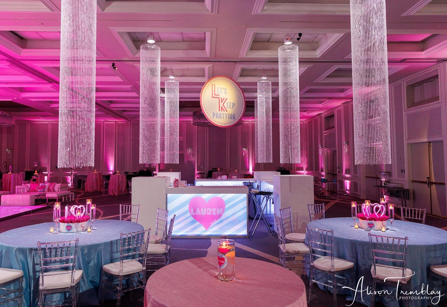 Vibrant Mitzvah celebration with pink uplighting and custom decor